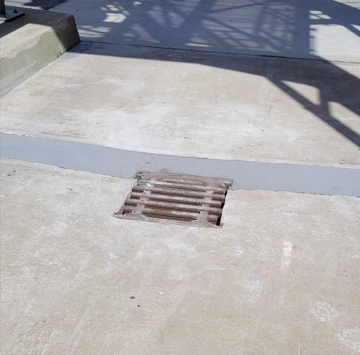Epoxy coating applied around an industrial floor drain grate