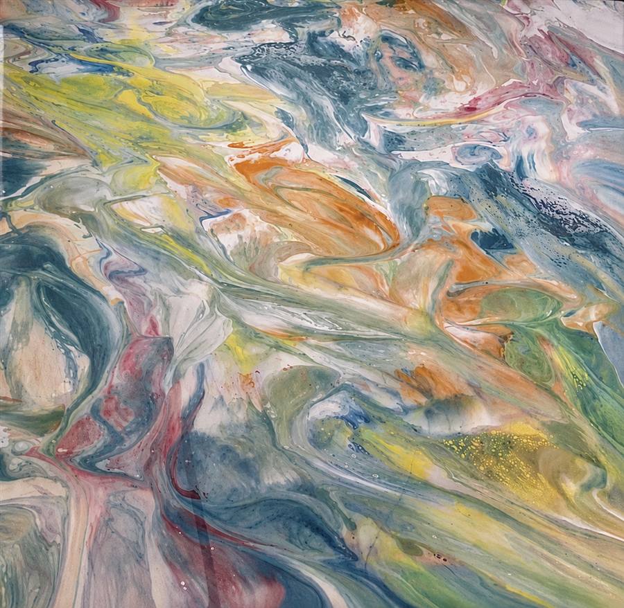 Close-up of a custom marbled epoxy floor with blue, yellow, and copper swirls