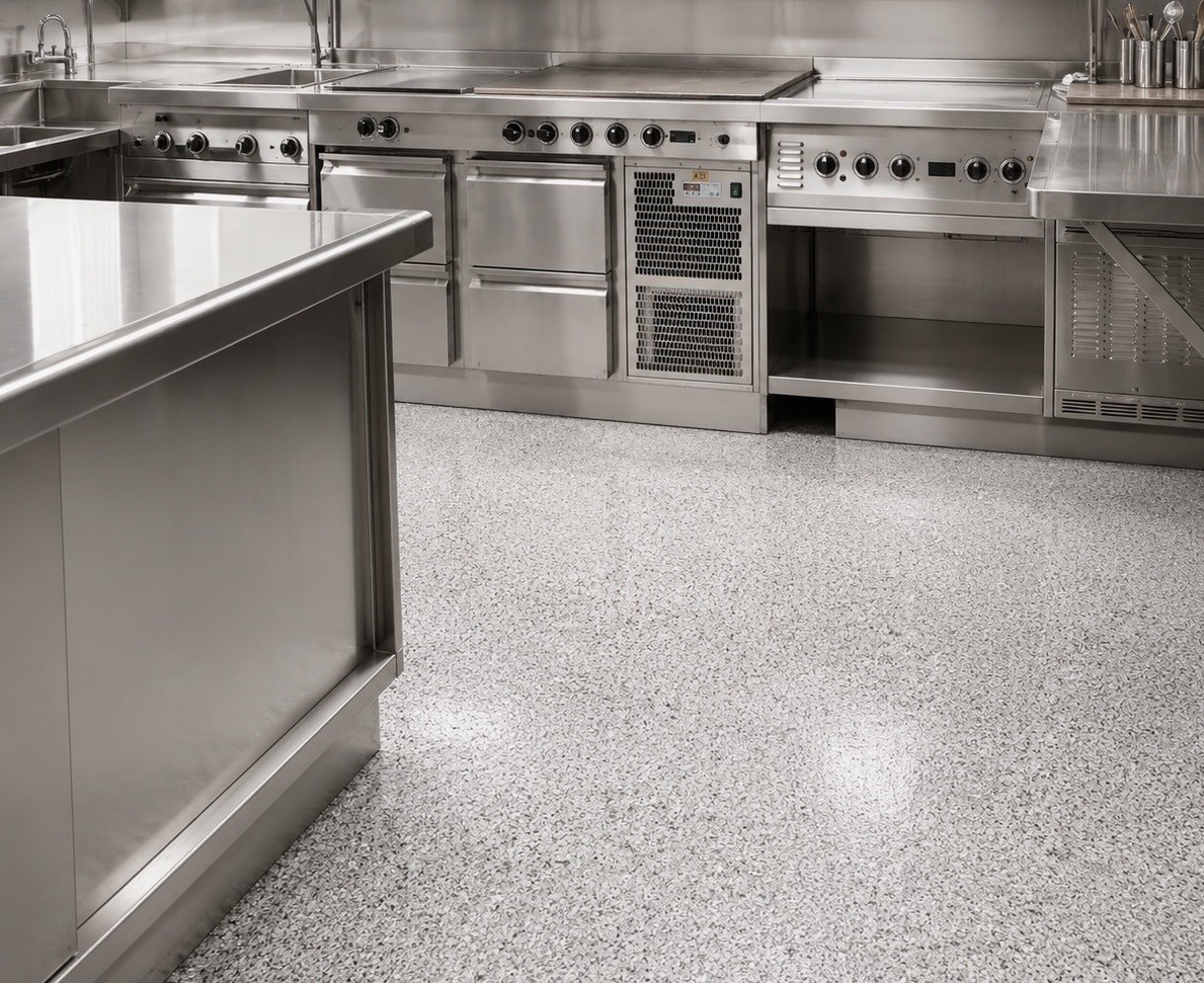 Speckled epoxy flake floor in a stainless steel commercial kitchen