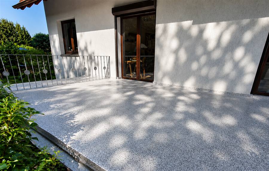 Grey and white flake epoxy coating on a residential outdoor patio